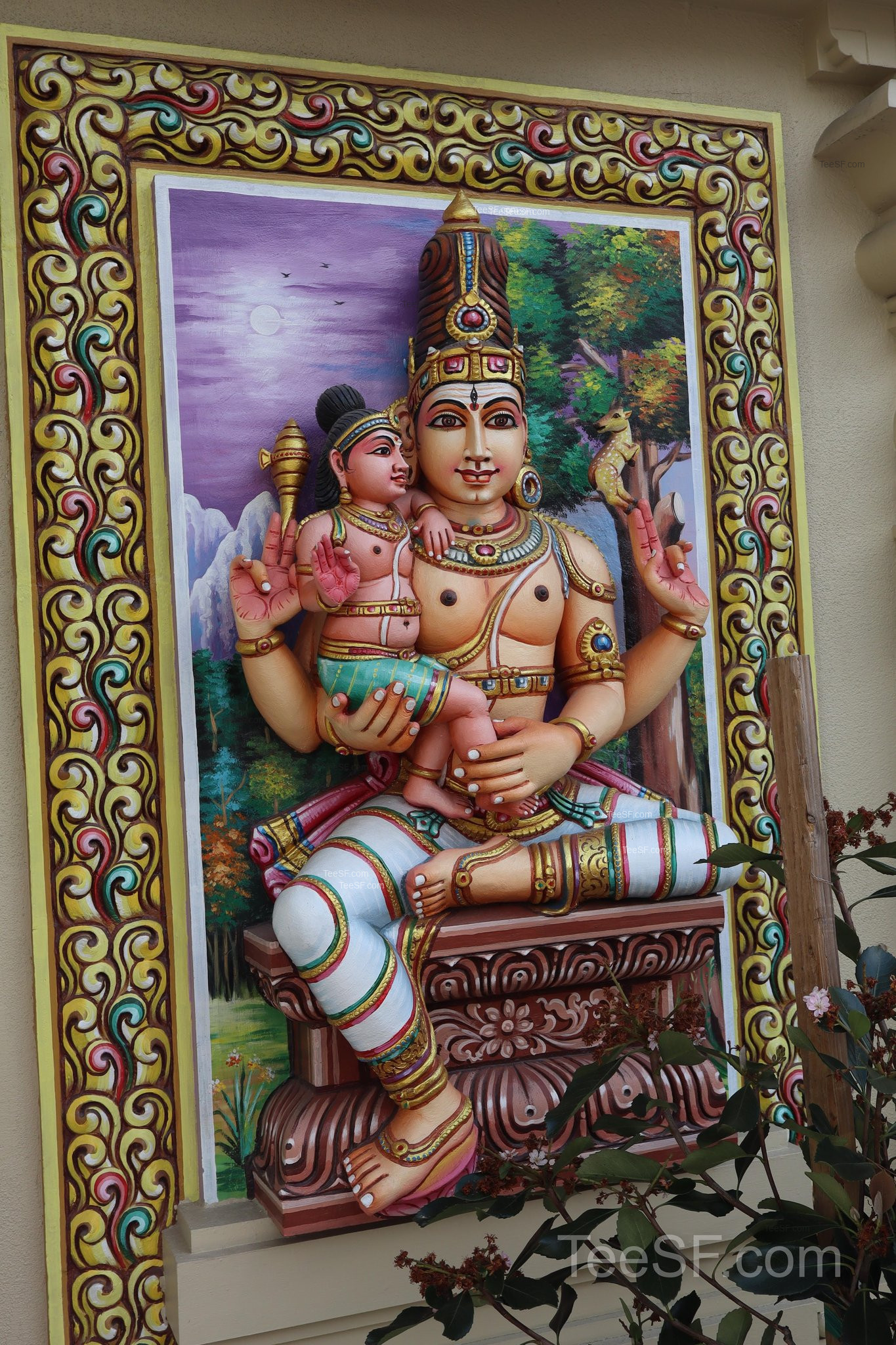 A framed temple artwork with bright colors and ornate detail.